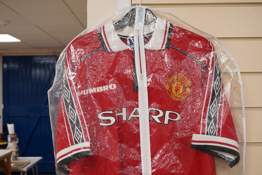 A Manchester United Umbro Sharp polo shirt, signed by David Beckham